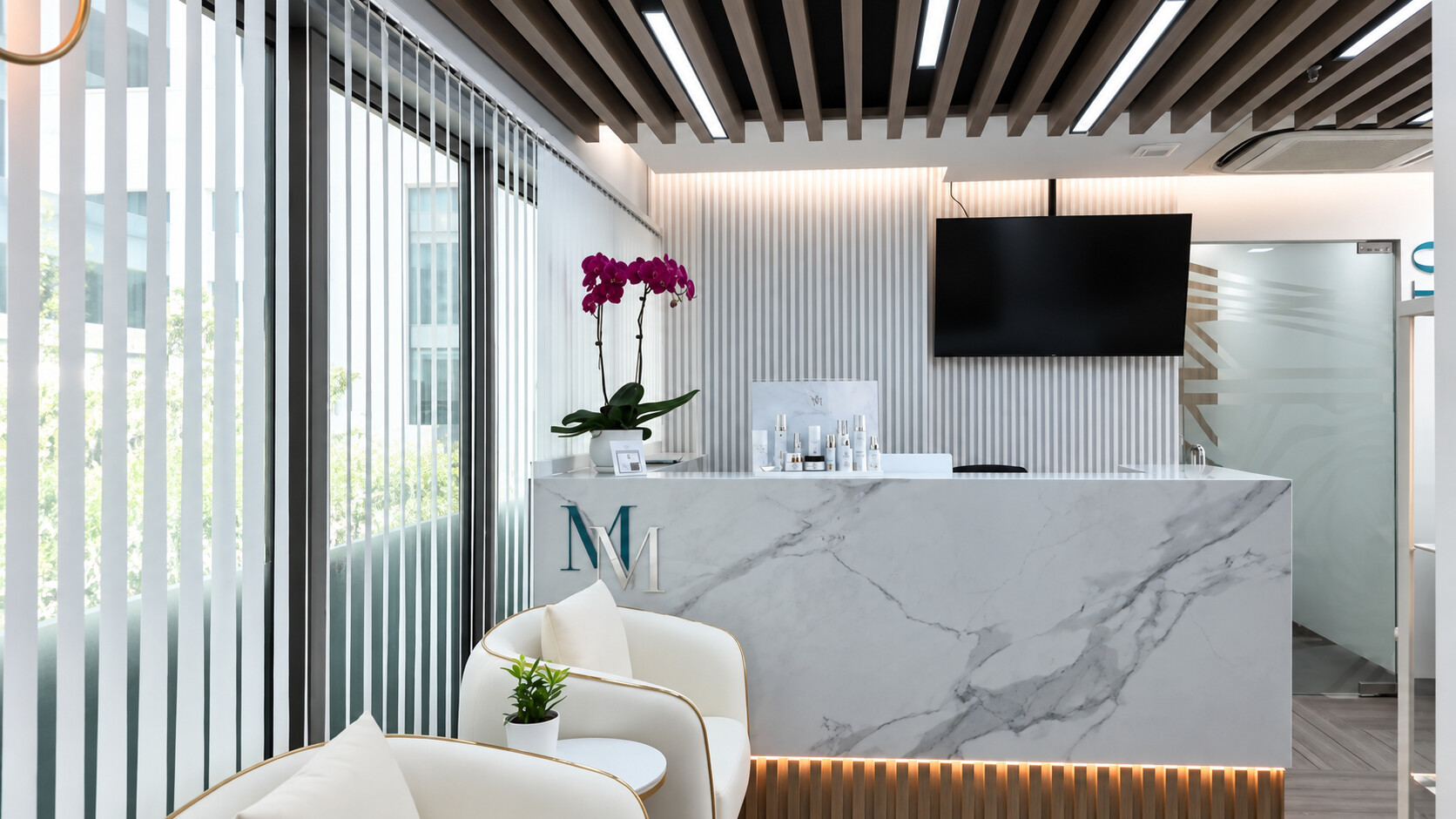 McKelvie Medical reception: marble-front desk, white chairs, orchid and slatted ceiling.